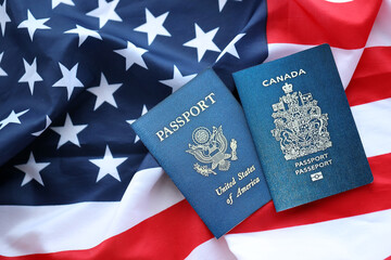 Passport of Canada with US Passport on United States of America folded flag close up