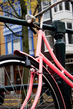 Detailed view of a vibrant pink bicycle's components with a focus on design and craftsmanship