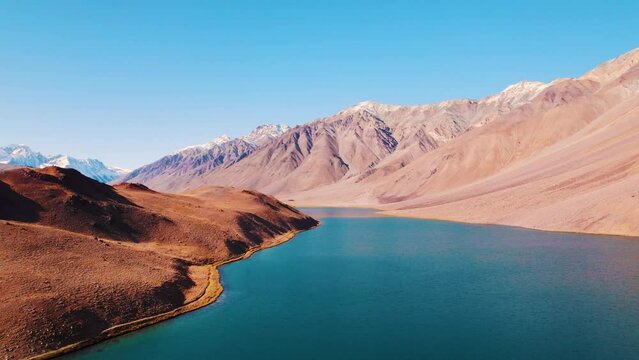 4K aerial shot of blue color Chandra Taal lake with Himalaya mountains in Spiti Valley, India. Beautiful aerial landscape of mountain lake. Travel, vacation and Holidays background.