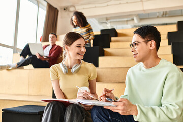 A man and woman with different ethnic backgrounds engaged in an animated conversation while seated on a chair