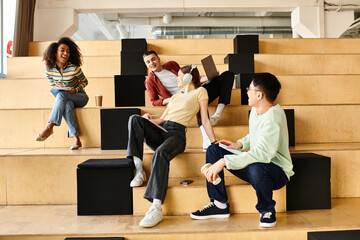 Multicultural students of varying backgrounds sit on a staircase, engrossed in conversation