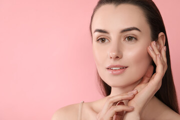 Portrait of beautiful young woman on pink background. Space for text