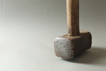 One sledgehammer on grey background, closeup. Space for text