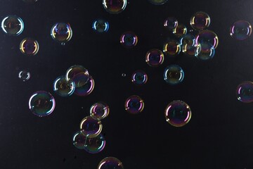 Beautiful transparent soap bubbles on dark background