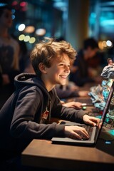 Fototapeta premium A young boy is sitting in front of a laptop at the VetalVit A coding club, learning and engaging with coding tasks. He is focused and absorbed in his work