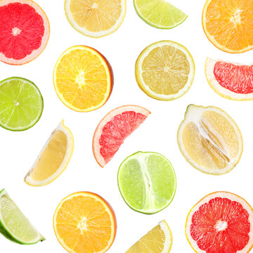 Many different fresh citrus fruits falling on white background