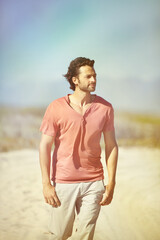 Man, walking and countryside with casual for journey, travel and vacation with grass and nature. Male person, hiking and sand road in Ukraine mountains for explore, trip and holiday from war