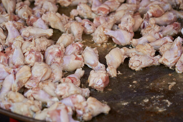 raw chicken legs in a pan