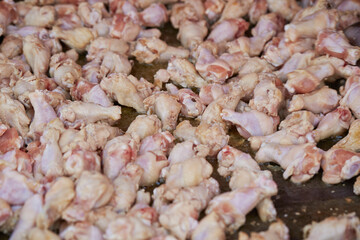 raw chicken legs in a pan