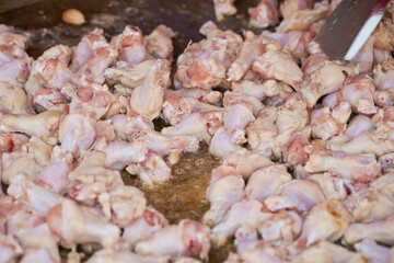 raw chicken legs in a pan