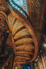 Fototapeta premium Porto, Portugal - October 30, 2023: Interior view of Lello bookstore (Portuguese: Livraria Lello) and its famous wooden staircase in historic center of Porto , famous for Harry Potter film (Porto)