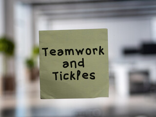 Post note on glass with 'Teamwork and Tickles'.