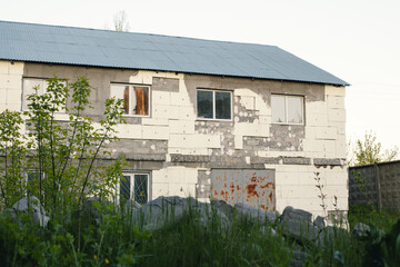 An old semi-ruined building with a large metal gate