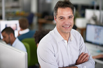 Businessman, smile and portrait with arms crossed in office for job in startup with closeup for work. Male person, manager and happy on desk with computer in company with entrepreneur for pride