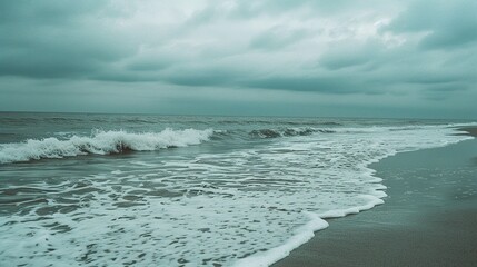 Fototapeta premium waves on the beach in gloomy summer weather
