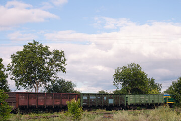 A freight train with wagons is moving along the rails