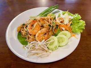 Pad thai, phat thai, or phad thai is a stir-fried rice noodle dish commonly served as a street food in Thailand as part of the country's cuisine.