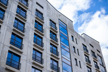 Large modern tall buildings with many balconies taken on a overcast background
