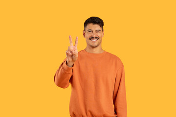 Man with moustache showing peace sign with fingers