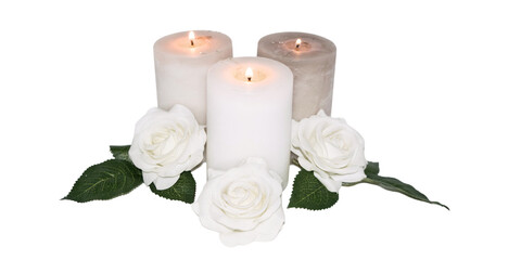 Three lit white candles with white roses around them