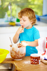 Messy, boy or eating of chocolate to play, learn or child development as growth milestone idea. Male youth, lick or fingers as playful, naughty or nutrition in holiday wellness activity in kitchen