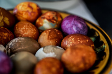 Colorful Easter eggs in brown plate
