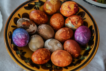 Colorful Easter eggs in brown plate