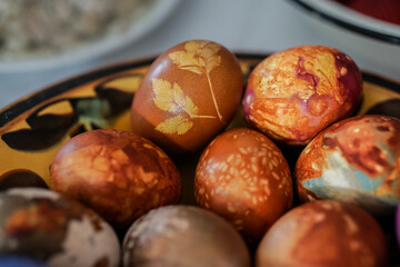 Colorful Easter eggs in brown plate
