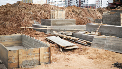 A concrete slab takes form amidst the hustle and bustle of a construction site, marking the beginning of a strong foundation