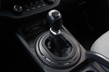 Manual gear stick inside modern car. Manual gearbox lever. Detail on a Manual gear shifter in a car. Six speed gear stick in car. Modern SUV interior.