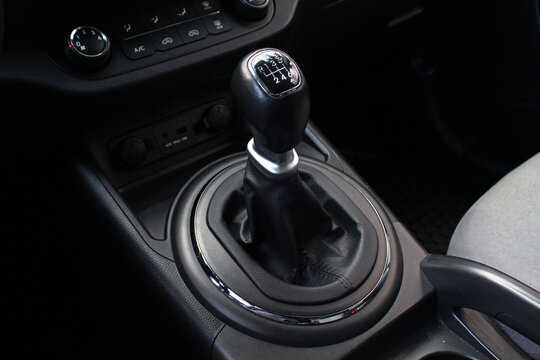 Manual gear stick inside modern car. Manual gearbox lever. Detail on a Manual gear shifter in a car. Six speed gear stick in car. Modern SUV interior.