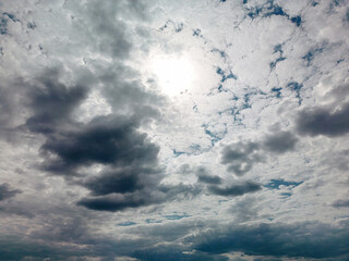 A cloudy sky stretches out above, with wispy clouds drifting in the distance