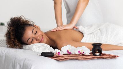 Obraz na płótnie Canvas Woman enjoying aroma massage in spa salon
