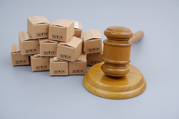 Tariffs and taxes concept. Gavel and many carton boxes.	