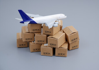 Transportation, delivery and shipping concept. Airplane on heap of carton boxes.	