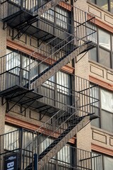 Vertical shot of a fire escape staircase of a brick building in New York, United States.