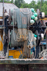 Vertical shot of a boat with fishing nets and ropes in Malaysia