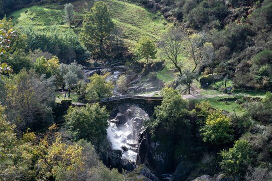 Drone footage of the Bridge of Mizarela with rich vegetation around crossing Rabagao river below