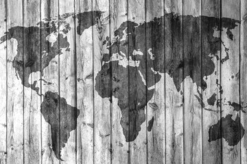 Monochrome photography of world map on wooden wall, forming intricate pattern