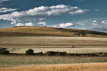 Fototapeta premium Tractor in a field on the isle of Wight under the cloudy sky