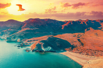 Aerial view of Rocky seashore with dramatic sunset sky. Seascape in the evening. Cabo de...