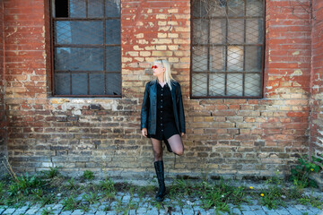 Young beautiful strong independent rebel blonde woman Punk music and style fan posing. Confident...