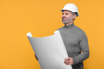 Architect in hard hat holding draft on orange background