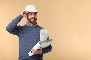 Architect in hard hat with draft and folder on beige background, space for text