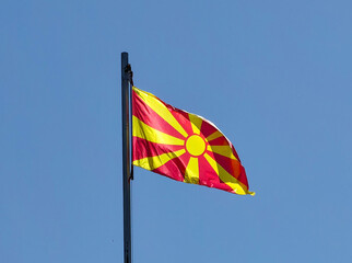 Sky ward . Waving  Macedonian flag, Windy dance . Cool breeze.  Red and yellow colors. Represent Republic of Macedonia