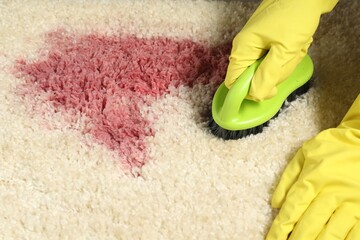 Woman removing stain from beige carpet, closeup - obrazy, fototapety, plakaty