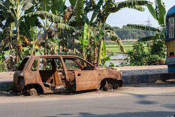 27th February, 2024, Baraipur, West Bengal India: A damaged broken useless car standing road side as a scrap.
