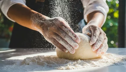 Foto op Plexiglas person kneads bread dough with flour on table in outdoor area © Wirestock