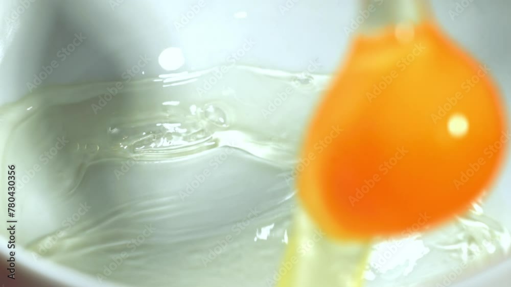 Sticker Super slow motion raw egg falls into a cap. High quality FullHD footage