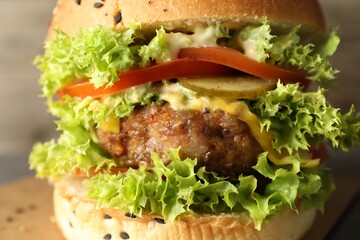 Burger with delicious patty on table, closeup